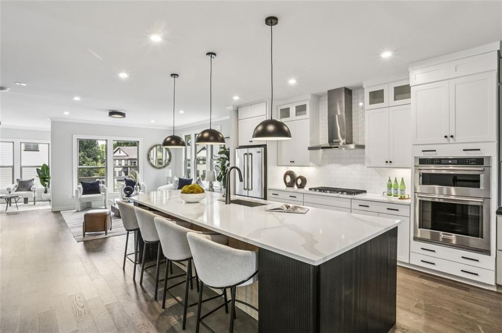 2090 Emmet Park Lane, Unit 425 Decatur, GA 30033 - Photo 23 of 102 a kitchen with appliances a stove a center island a dining table and chairs