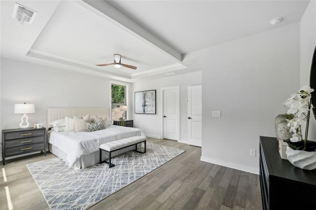 2090 Emmet Park Lane, Unit 425 Decatur, GA 30033 - Photo 45 of 102 a bedroom with a bed and wooden floor
