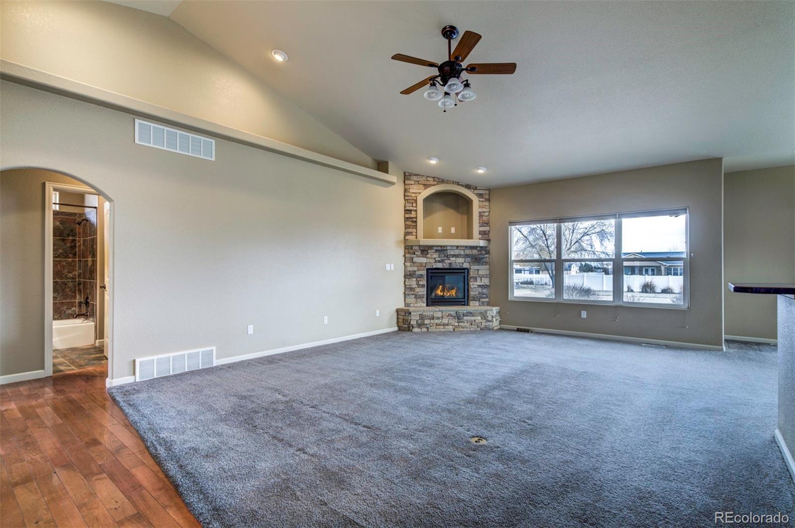 24484 Gale Road Pueblo, CO 81006 - Photo 11 of 43 a view of an empty room with a window and a kitchen