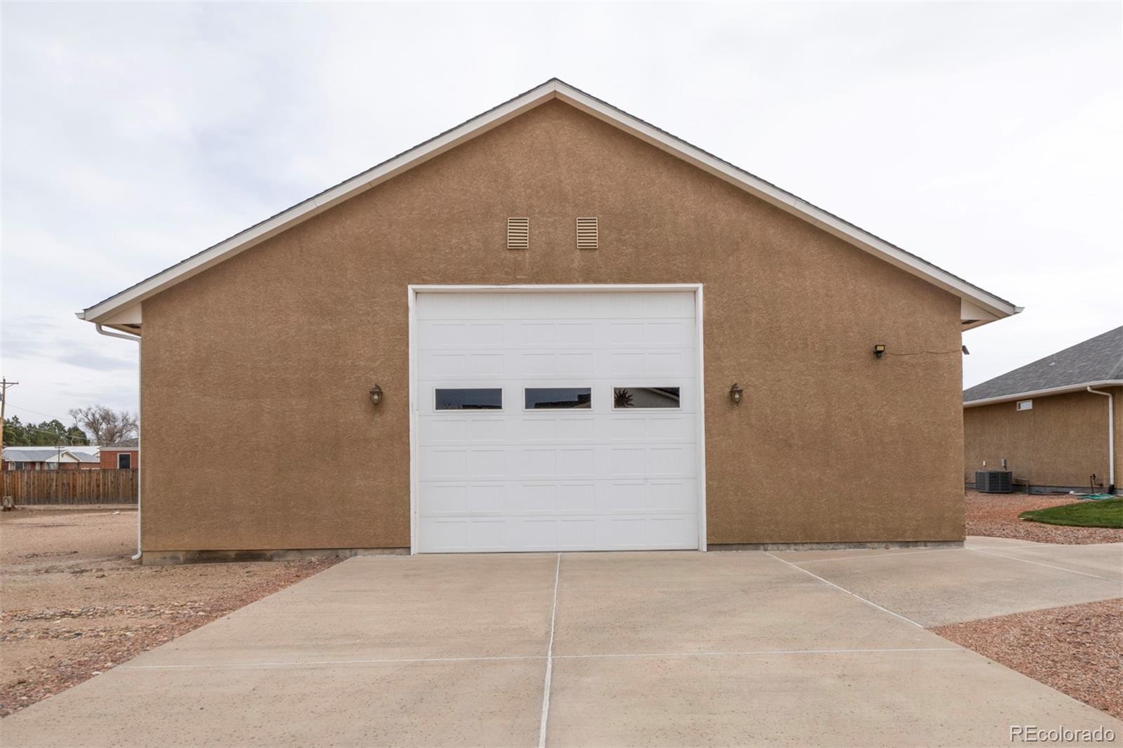 24484 Gale Road Pueblo, CO 81006 - Photo 5 of 43 a front view of a house with garage