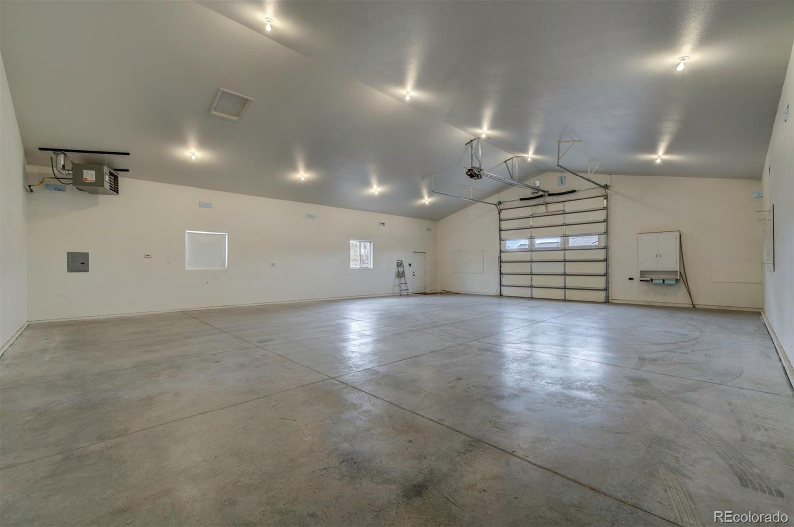 24484 Gale Road Pueblo, CO 81006 - Photo 8 of 43 an empty room with windows and pillars in it