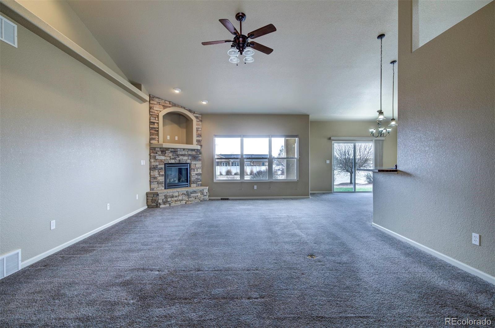 24484 Gale Road Pueblo, CO 81006 - Photo 10 of 43 en view interior of a house with a fireplace and windows