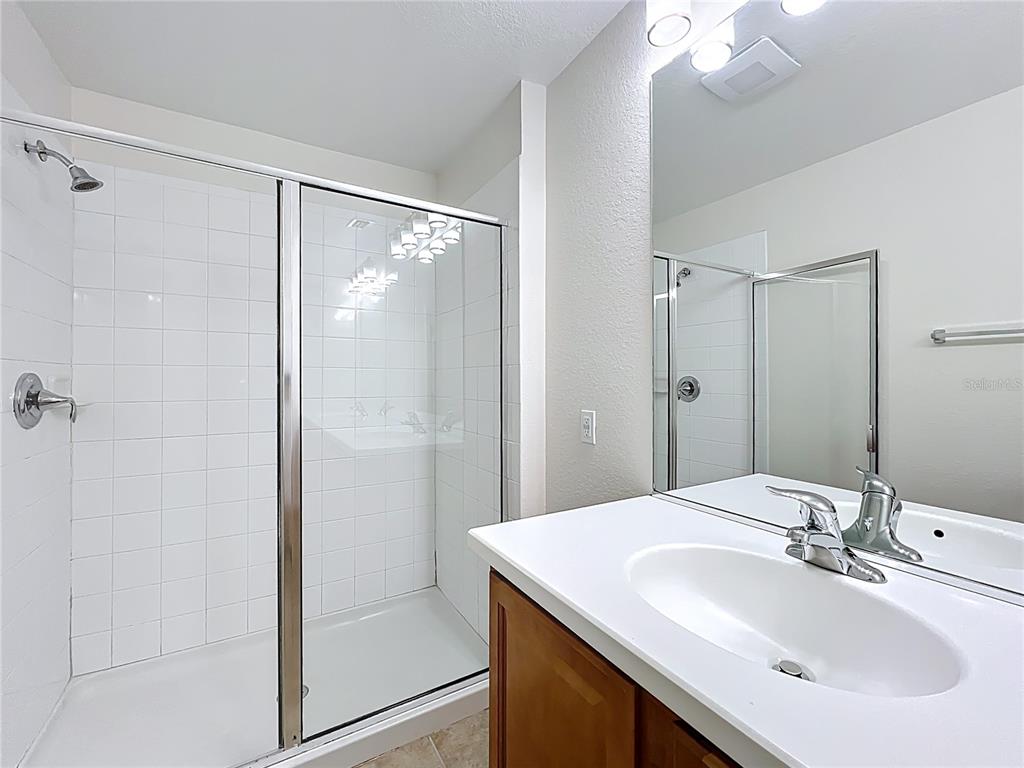 12930 Vennetta Way Windermere, FL 34786 - Photo 21 of 38 a bathroom with a sink shower and a mirror