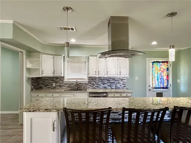 a bathroom with a granite countertop toilet sink and mirror