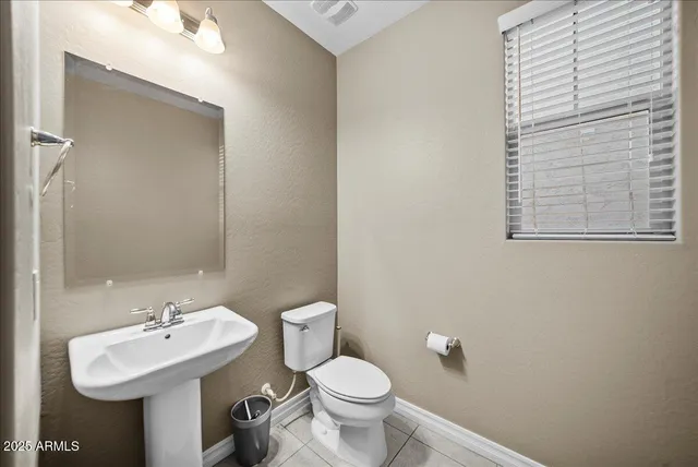 a living room with a large mirror and furniture