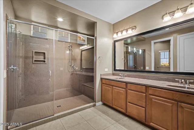 a spacious bedroom with a bed and a chandelier