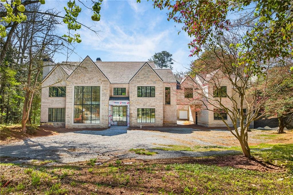 312 Blackland Road Northwest Atlanta, GA 30342 - Photo 2 of 58 a front view of a house with a garden