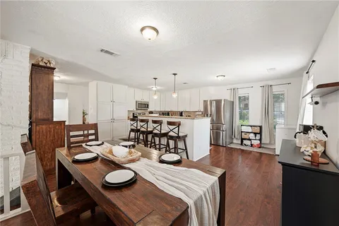 a view of a dining room with furniture and wooden floor