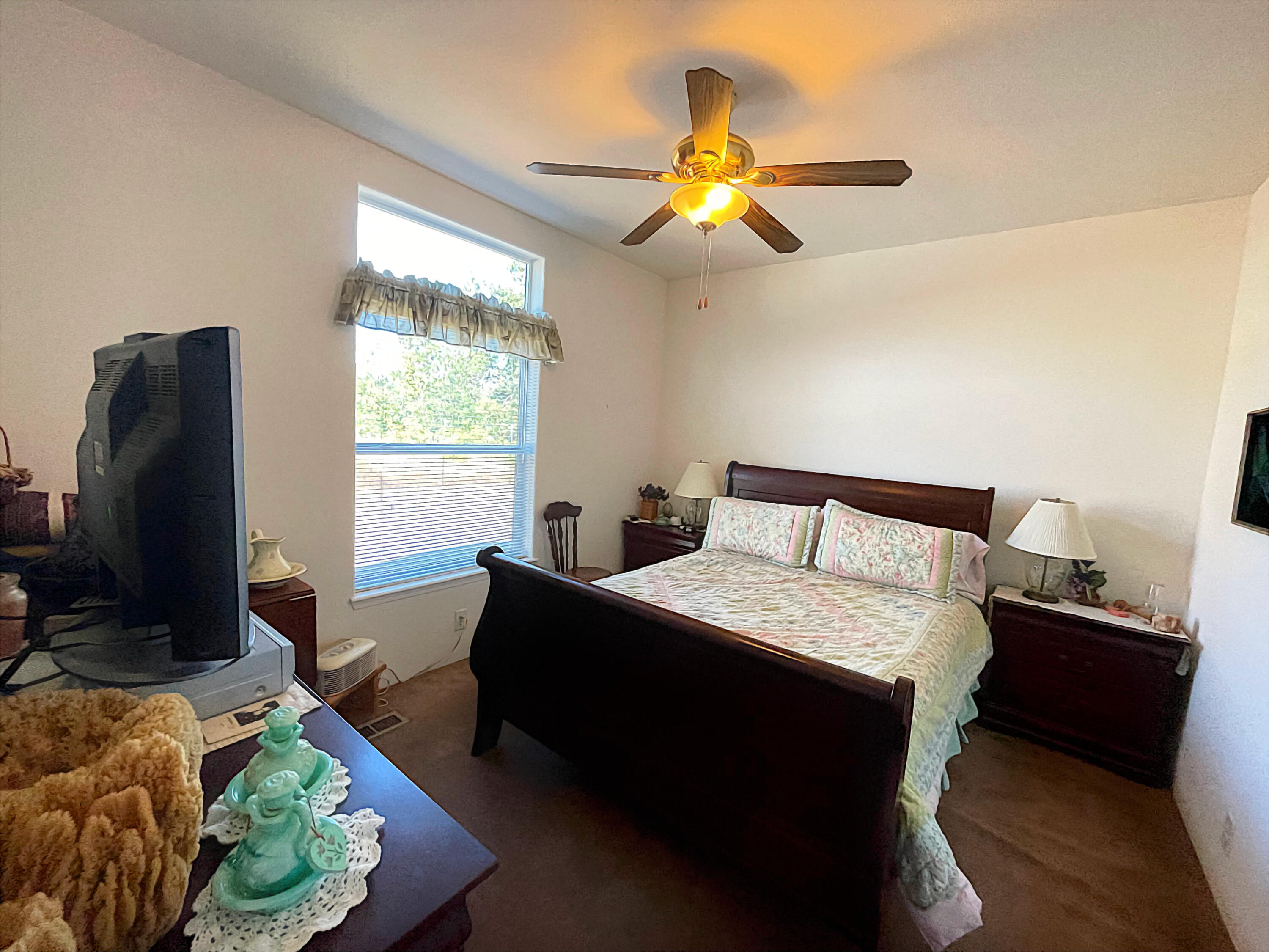 4911 Rockydale Road Cave Junction, OR 97523 - Photo 23 of 25 a bed room with a bed and a chandelier