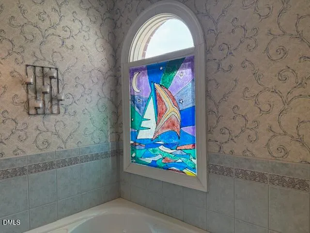 a view of a livingroom with wooden floor and a ceiling fan