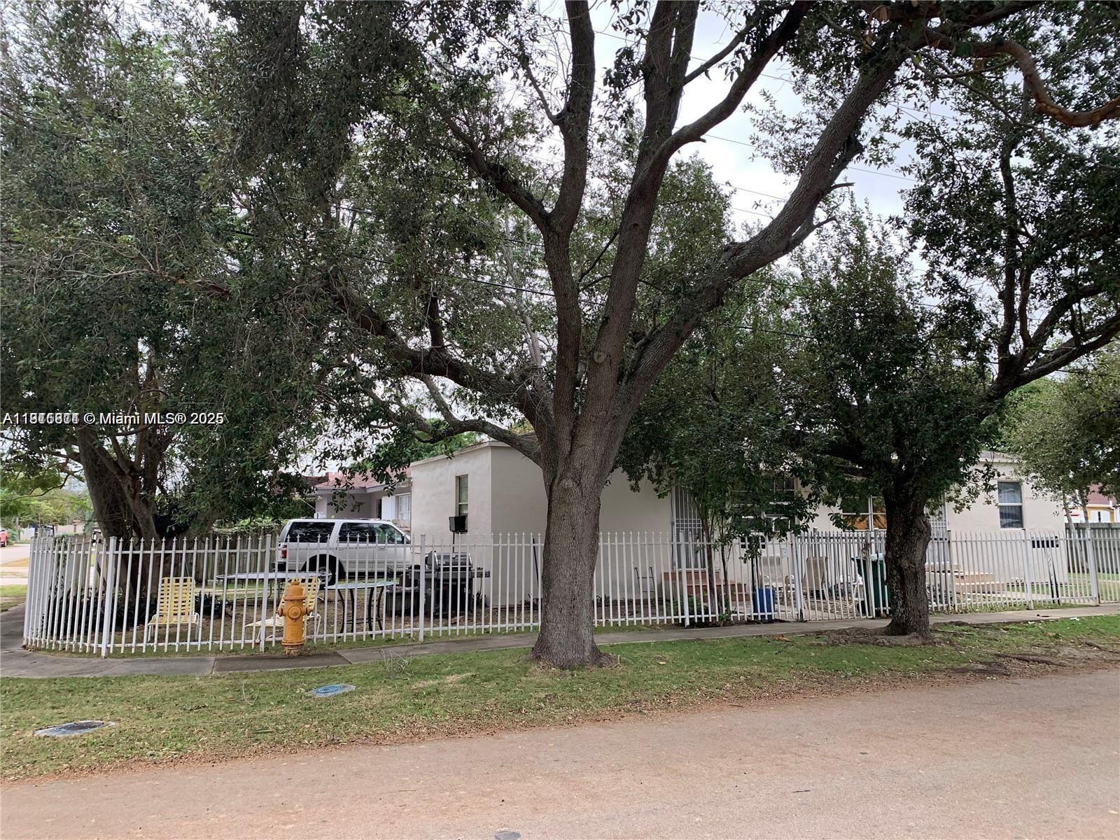 401 Northwest 81st Street Miami, FL 33150 - Photo 2 of 10 a backyard of a house with lots of trees
