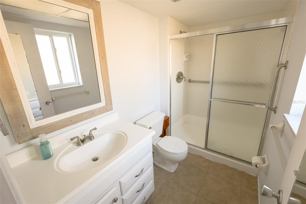 2003 Greenbriar Boulevard, Unit 1 Clearwater, FL 33763 - Photo 12 of 20 a bathroom with a sink toilet and shower