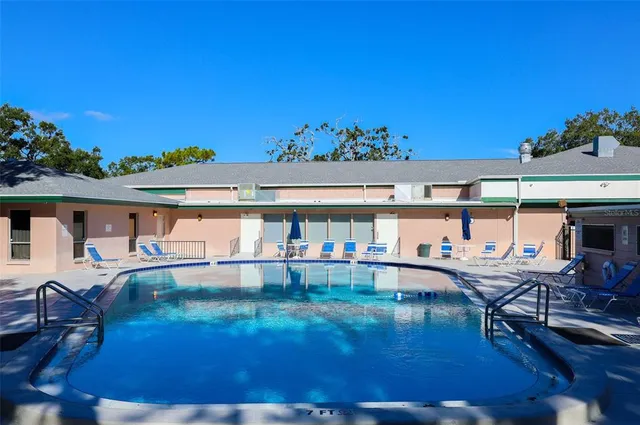 a view of a swimming pool with outdoor seating