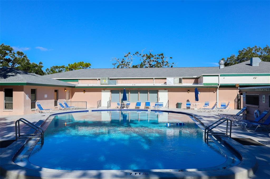 2003 Greenbriar Boulevard, Unit 1 Clearwater, FL 33763 - Photo 2 of 20 a view of a swimming pool with outdoor seating