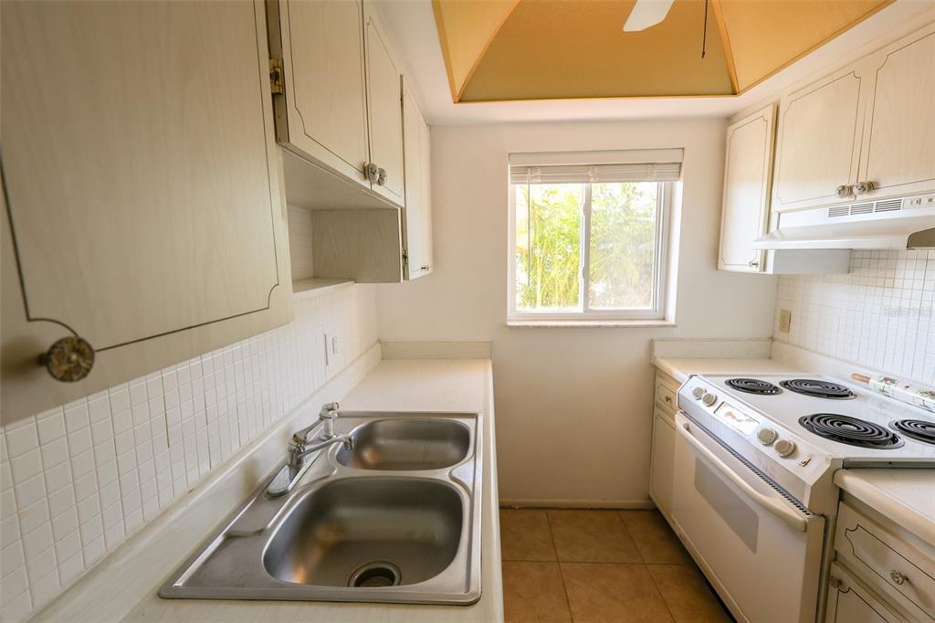 2003 Greenbriar Boulevard, Unit 1 Clearwater, FL 33763 - Photo 6 of 20 a kitchen that has a sink a stove and window