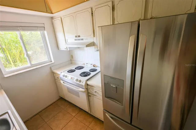 a kitchen with a refrigerator a stove a washer and dryer