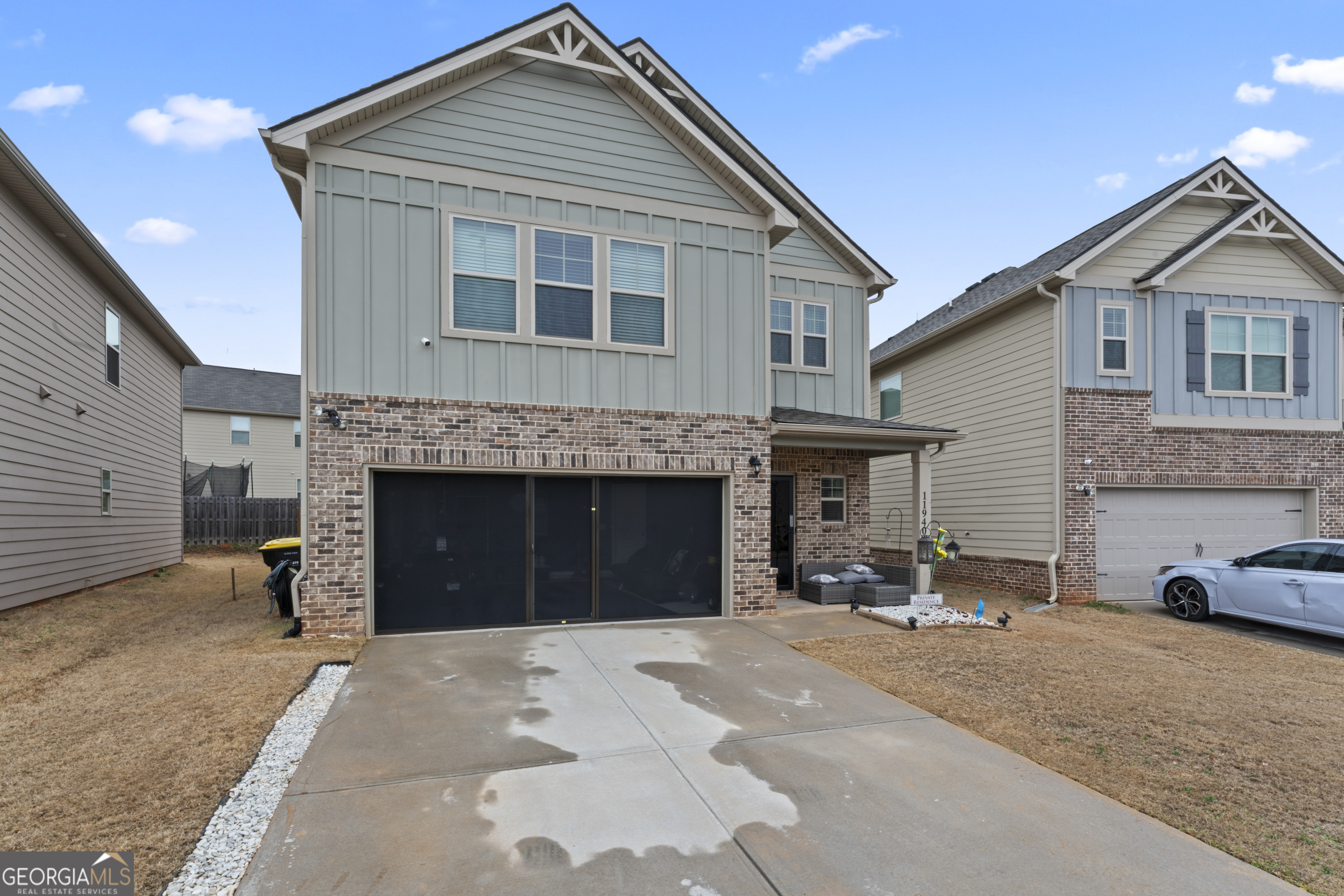 a front view of a house with a yard and a garage