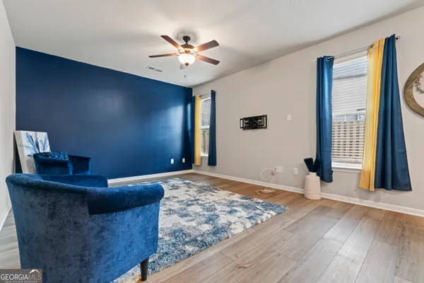 a living room with couches and chandelier