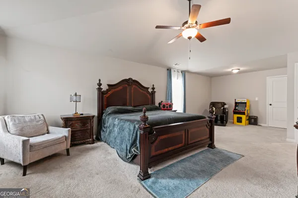 a bedroom with bed and a chandelier