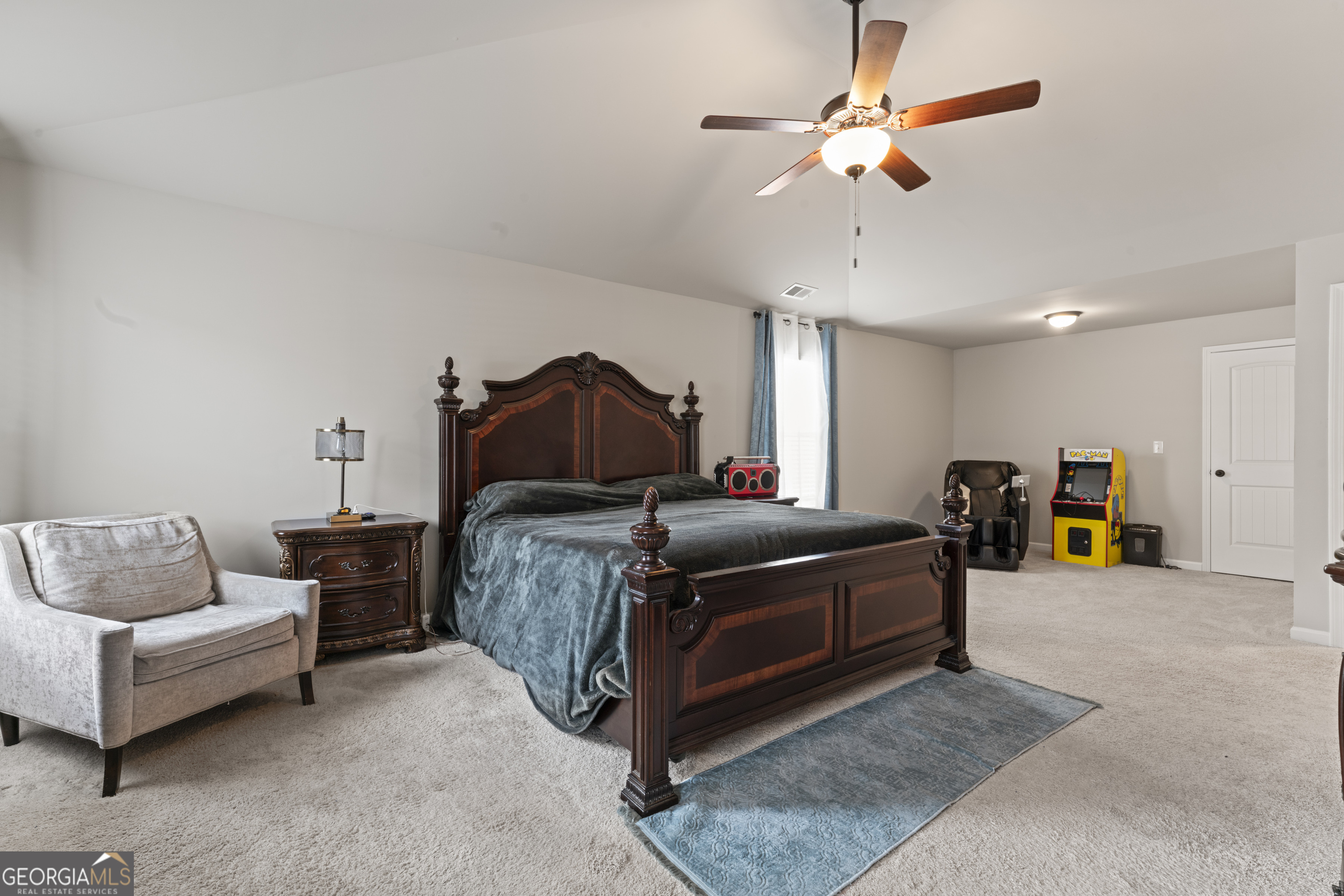 11940 Brightside Parkway Hampton, GA 30228 - Photo 16 of 29 a bedroom with bed and a chandelier