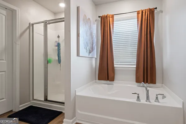 a bathroom with a bathtub and a shower