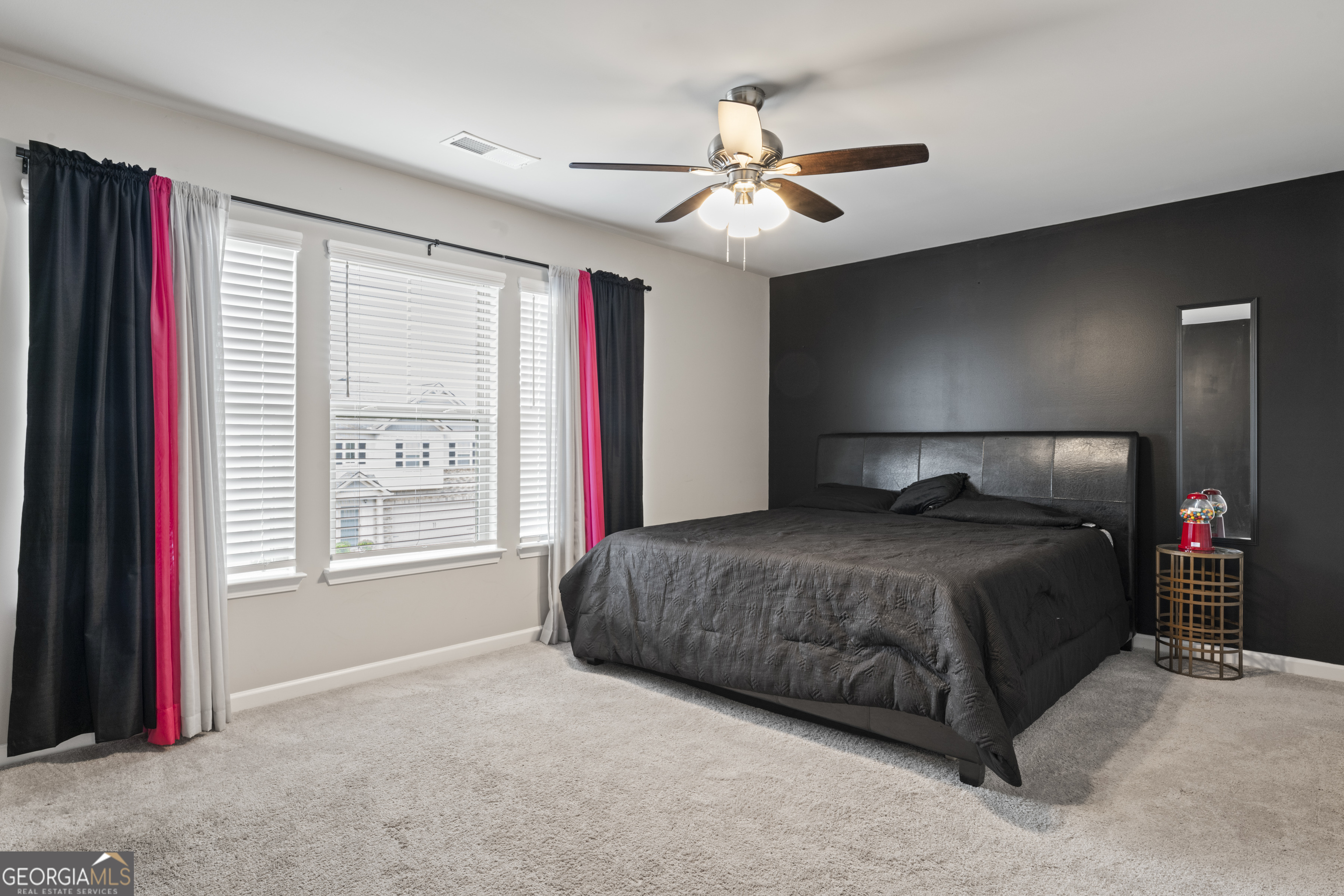 11940 Brightside Parkway Hampton, GA 30228 - Photo 19 of 29 a bedroom with a bed and a chandelier