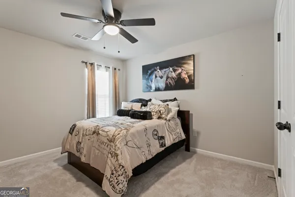 a bedroom with bed and a window