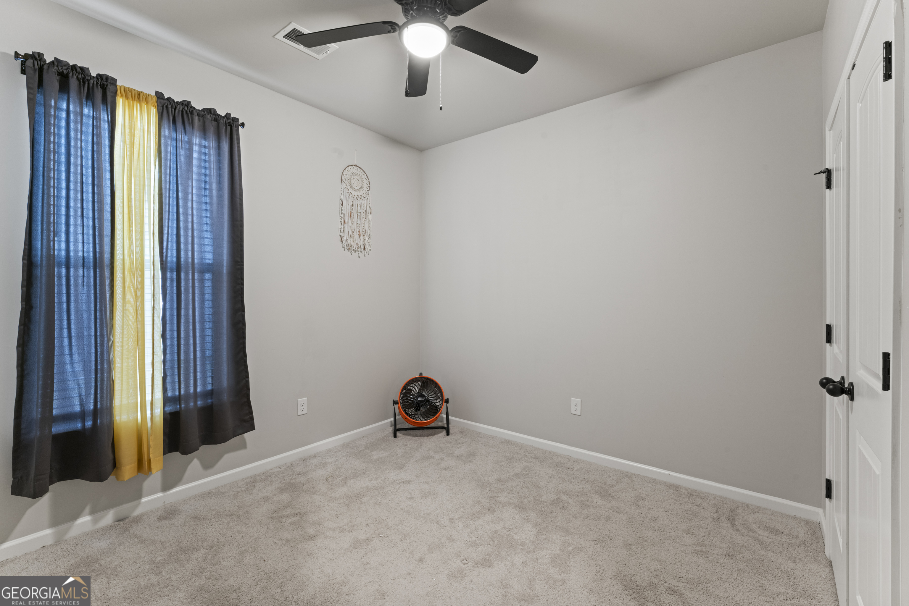 11940 Brightside Parkway Hampton, GA 30228 - Photo 23 of 29 an empty room with closet and windows