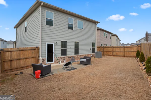 a view of a chairs and tables in the back yard of the house