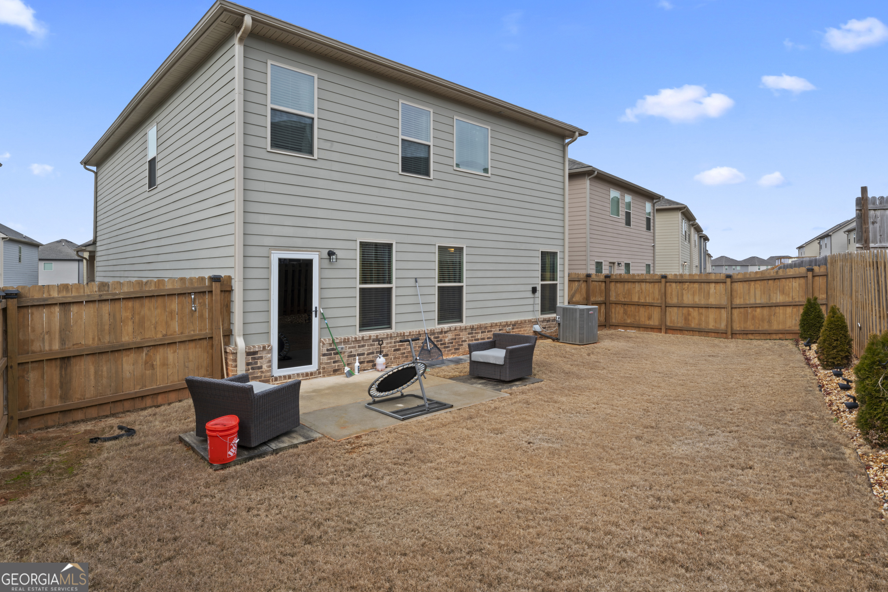 11940 Brightside Parkway Hampton, GA 30228 - Photo 28 of 29 a view of a chairs and tables in the back yard of the house