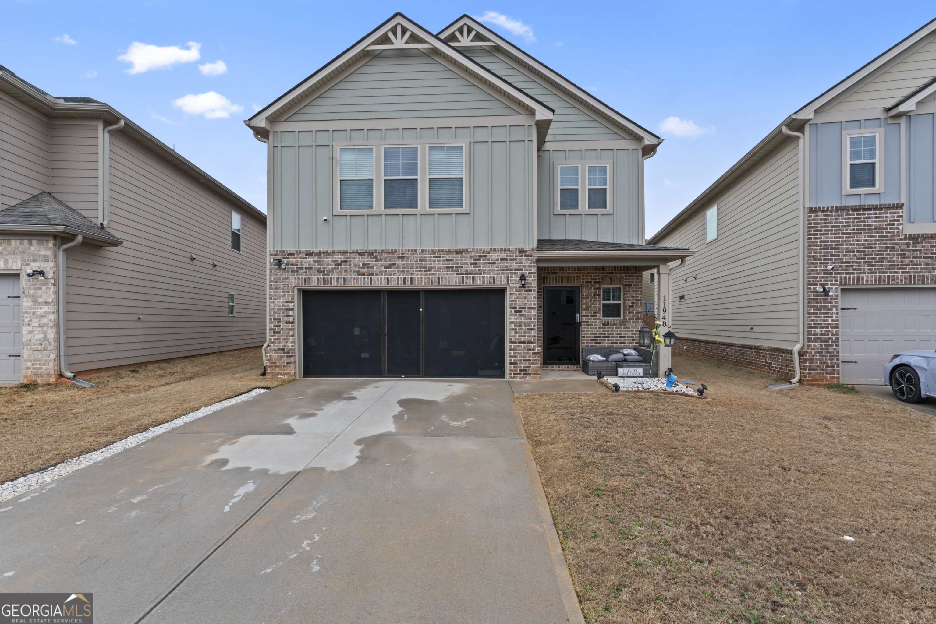 11940 Brightside Parkway Hampton, GA 30228 - Photo 3 of 29 a front view of a house with a yard and a garage