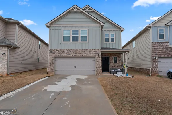 a front view of a house with a yard and garage