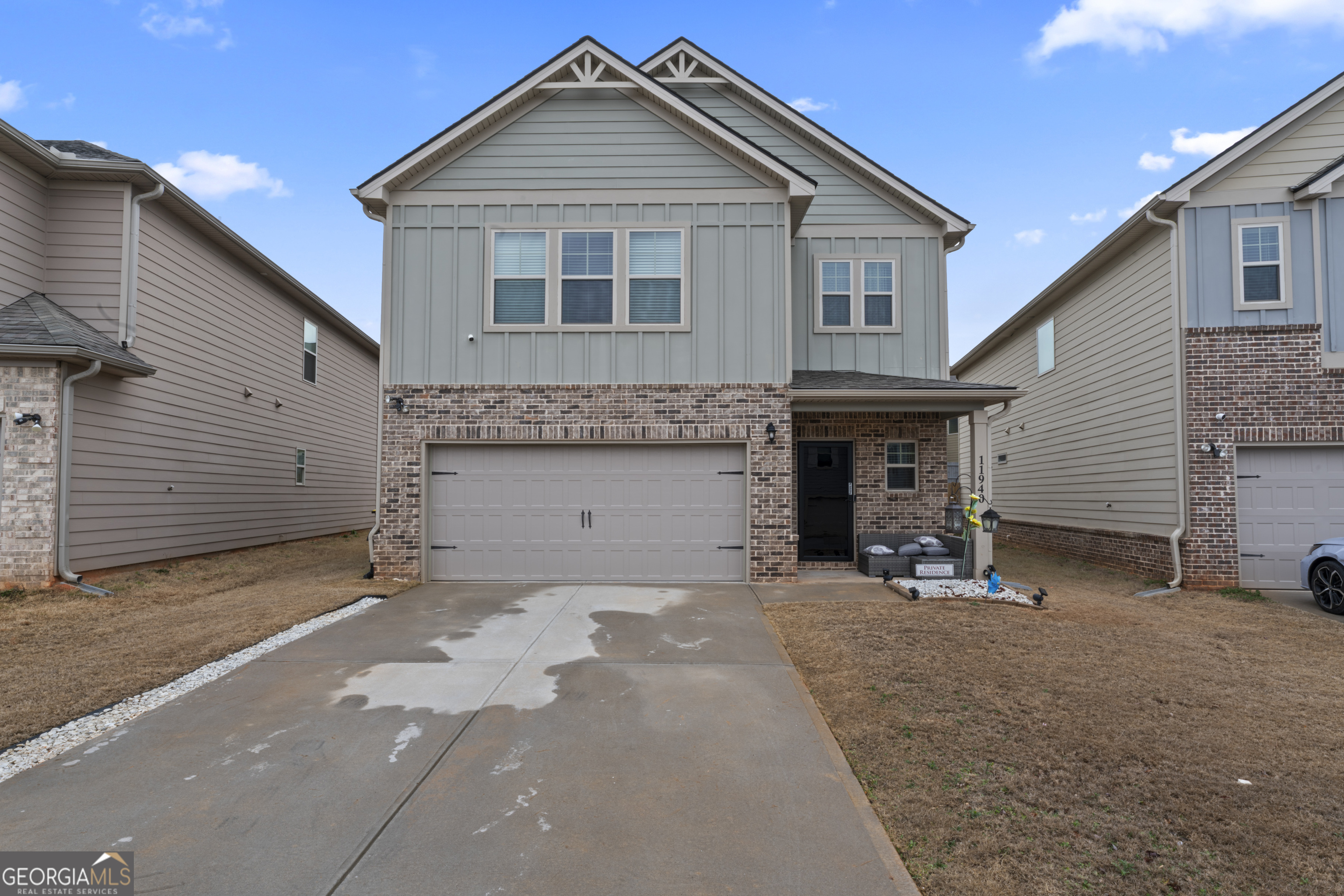 11940 Brightside Parkway Hampton, GA 30228 - Photo 4 of 29 a front view of a house with a yard and garage