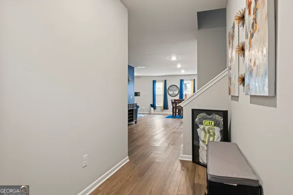a view of entryway and hall with wooden floor