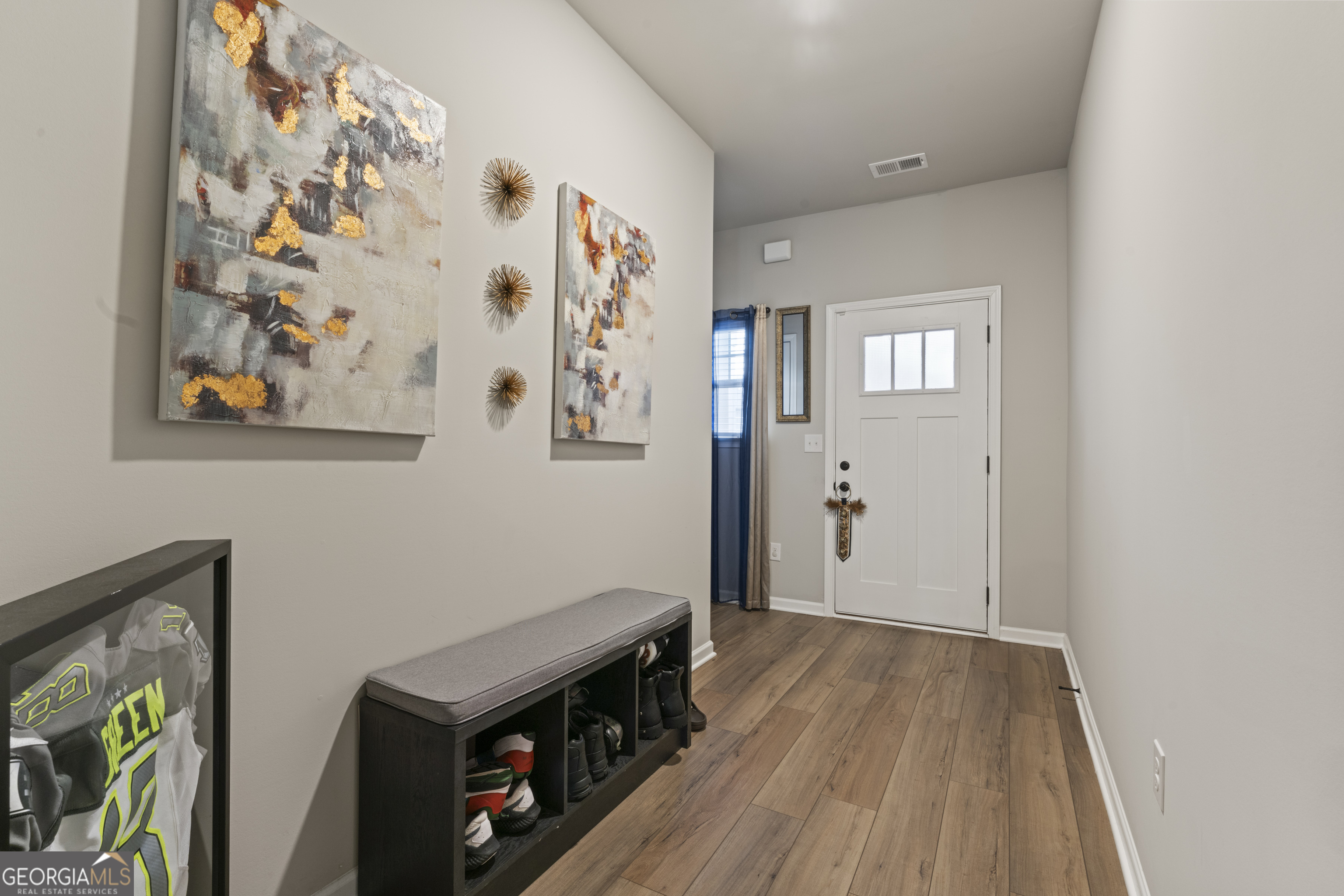 11940 Brightside Parkway Hampton, GA 30228 - Photo 7 of 29 a view of a hallway with wooden floor