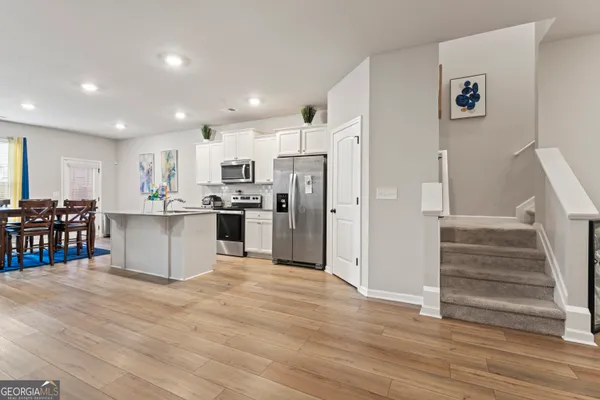 a kitchen with stainless steel appliances a refrigerator and a stove top oven