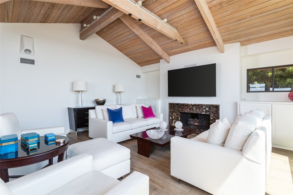810 Emerald Bay Laguna Beach, CA 92651 - Photo 13 of 28 a living room with furniture a flat screen tv and a fireplace