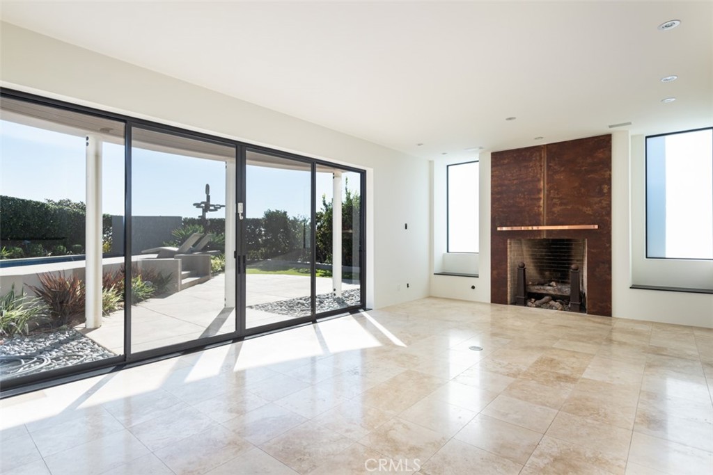 810 Emerald Bay Laguna Beach, CA 92651 - Photo 14 of 28 a view of a livingroom with a fireplace and window