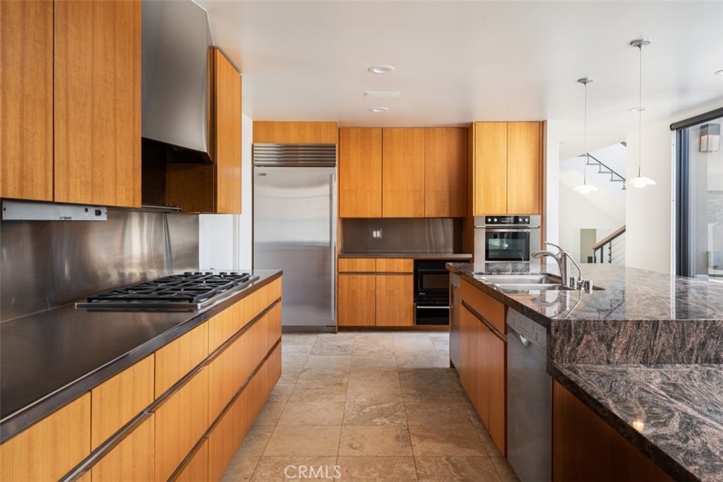 810 Emerald Bay Laguna Beach, CA 92651 - Photo 17 of 28 a kitchen with stainless steel appliances granite countertop a stove a sink and a microwave
