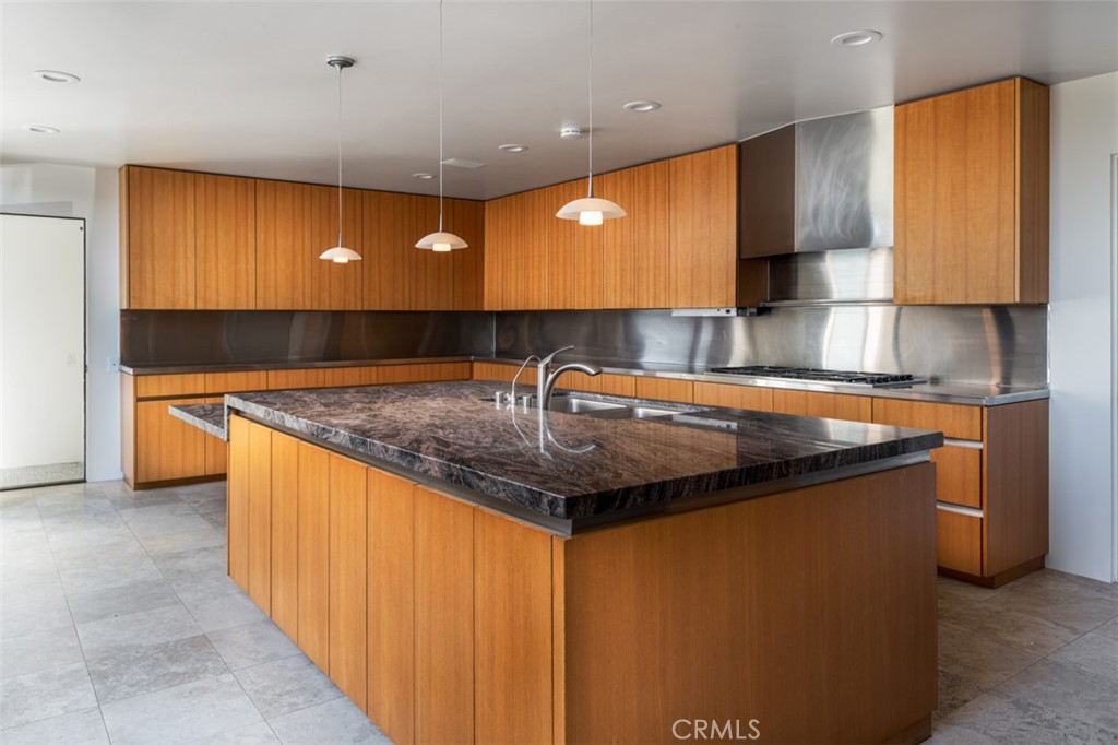 810 Emerald Bay Laguna Beach, CA 92651 - Photo 18 of 28 a kitchen with stainless steel appliances granite countertop a sink and a wooden cabinets