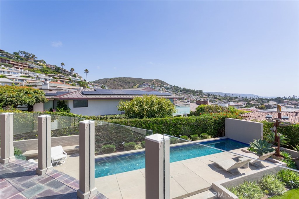 810 Emerald Bay Laguna Beach, CA 92651 - Photo 3 of 28 a view of a patio with couches chairs and a floor to ceiling window