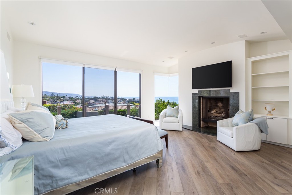 810 Emerald Bay Laguna Beach, CA 92651 - Photo 6 of 28 a bedroom with a bed window and a fireplace