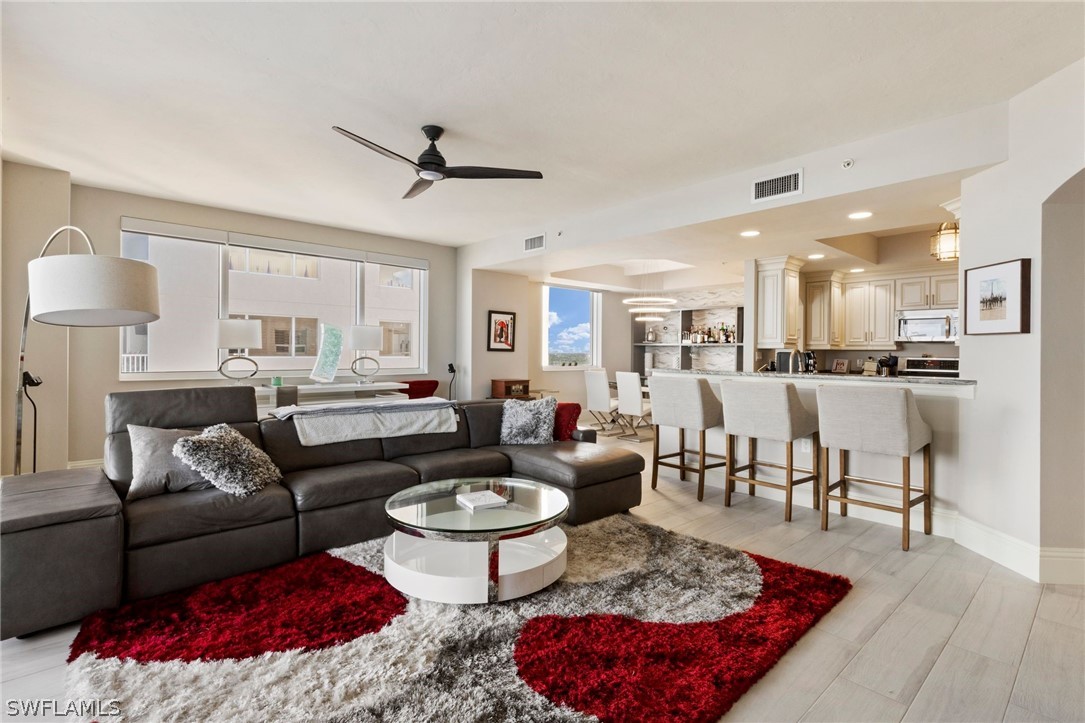 2104 West First Street, Unit 1404 Fort Myers, FL 33901 - Photo 11 of 30 a living room with furniture kitchen view and a table
