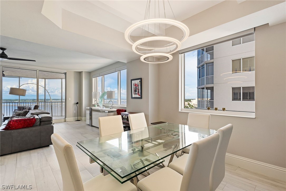 2104 West First Street, Unit 1404 Fort Myers, FL 33901 - Photo 12 of 30 a view of a dining room with furniture and a chandelier