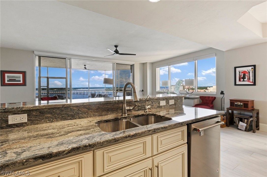2104 West First Street, Unit 1404 Fort Myers, FL 33901 - Photo 16 of 30 a kitchen with stainless steel appliances granite countertop a sink a stove and cabinets
