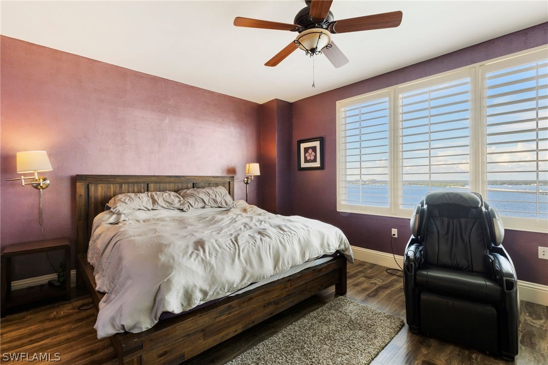 2104 West First Street, Unit 1404 Fort Myers, FL 33901 - Photo 18 of 30 a bed sitting in a bedroom next to a window