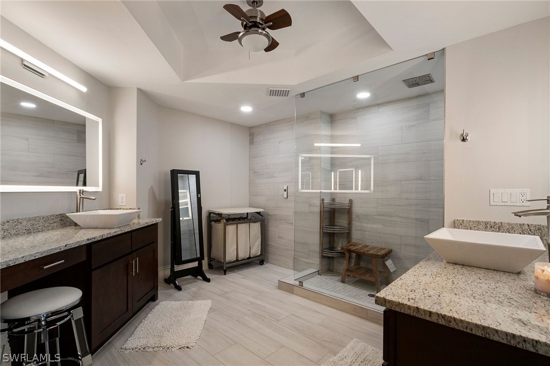 2104 West First Street, Unit 1404 Fort Myers, FL 33901 - Photo 20 of 30 a bathroom with double sink and a mirror