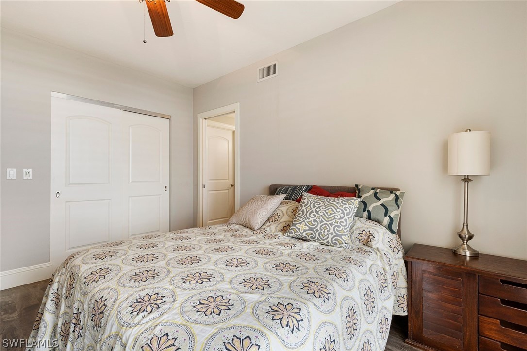 2104 West First Street, Unit 1404 Fort Myers, FL 33901 - Photo 23 of 30 a bedroom with a bed and a dresser