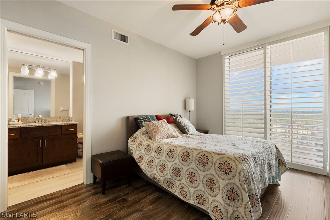 2104 West First Street, Unit 1404 Fort Myers, FL 33901 - Photo 24 of 30 a bedroom with a bed and wooden floor