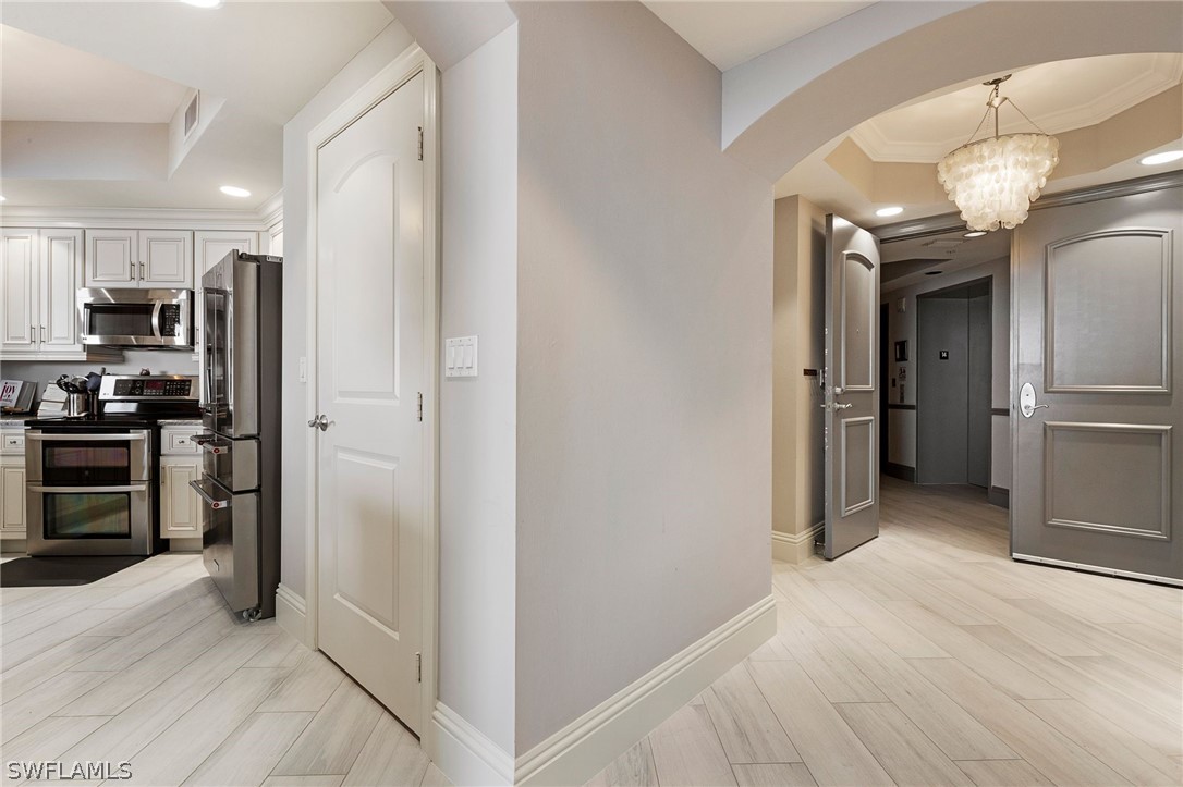 2104 West First Street, Unit 1404 Fort Myers, FL 33901 - Photo 9 of 30 a view of a kitchen from the hallway